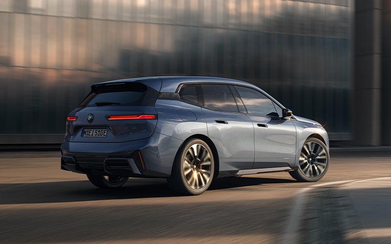 The BMW iX driving with the front wheel turned. | Enterprise BMW in Appleton WI